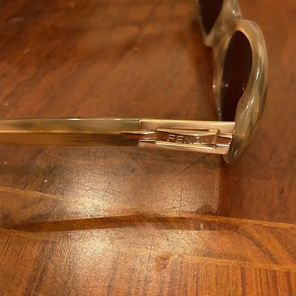 Fendi beige round with gold Fendi name on both sides display picture 3